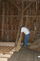 Me starting to put down the first pieces of the new flooring in the barn...